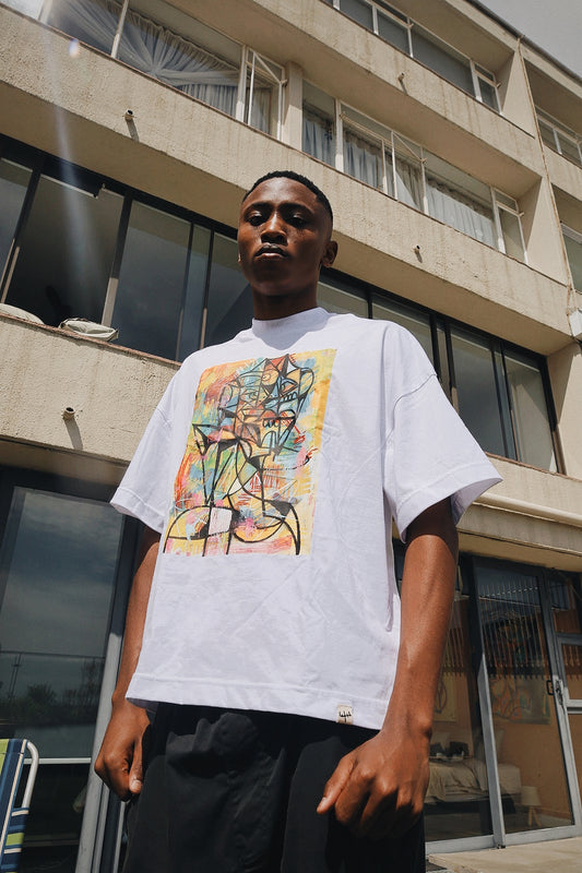Samurai Farai Energy in Motion T-Shirt 2026 - oversized white graphic tee featuring vibrant abstract expressionist artwork with bold black linework and colorful brushstrokes in yellow teal pink and orange, styled with black pants